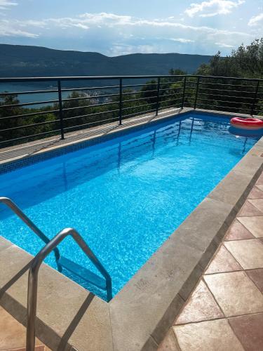 a large swimming pool on top of a building at Villa Tre Tri in Herceg-Novi