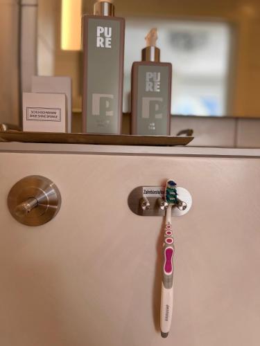 a toothbrush on top of a refrigerator with a counter at Hotel Haus Loewe in Frechen
