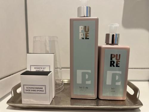 a couple of bottles ofodorizers sitting on a table at Hotel Haus Loewe in Frechen