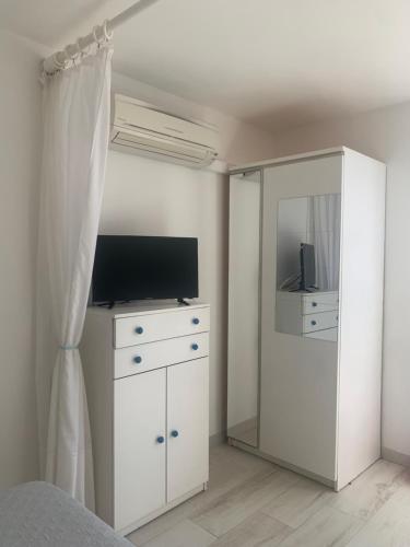 a bedroom with a bed and a dresser and a mirror at Monolocale “La Panoramica” in Rio Marina