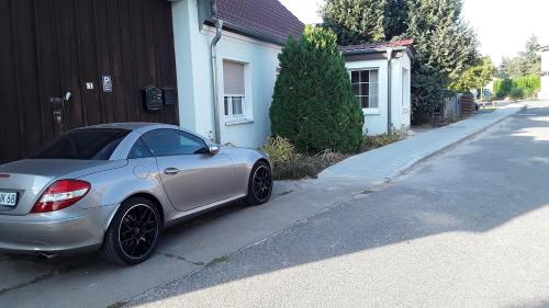 a silver car parked in front of a house at Ferienwohnung 1 Locktow in Locktow