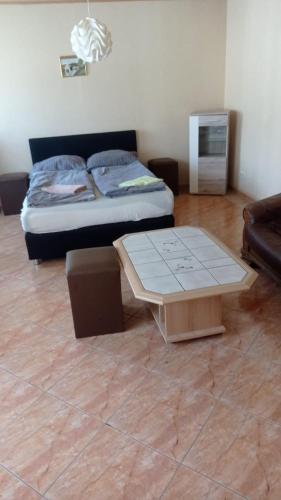 a living room with a bed and a coffee table at Ferienwohnung 1 Locktow in Locktow