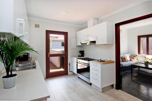 a kitchen with a sink and a stove at Villa Marbella by Slow Villas in Playa de Palma