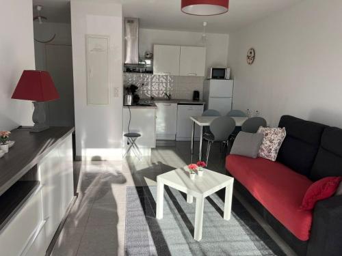 a living room with a couch and a table at Appartement La Villa Gayrou in Vieux-Boucau-les-Bains