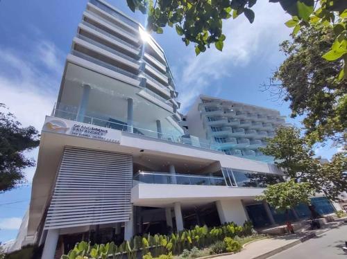 a building with a tall building in front of it at Grand Sirenis San Andres in San Andrés