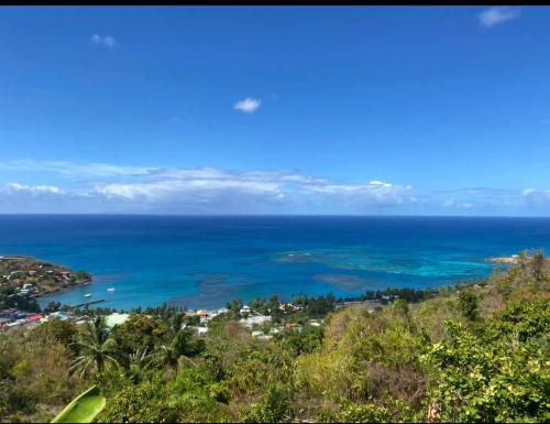 a view of the ocean from the top of a hill at LE BLANC HIDEAWAY in Laborie