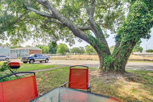 a picnic table in front of a tree at Airy Biloxi Condo with Patio Walk to Beach! in Biloxi