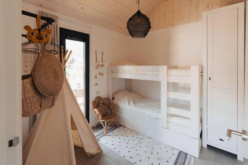 ein Schlafzimmer mit einem Etagenbett in einem Zimmer in der Unterkunft Fika Tiny House in Epe