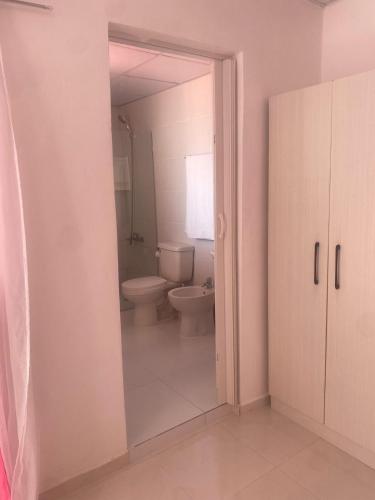 a bathroom with a toilet and a sink at Residencial Lucy in Boca Chica