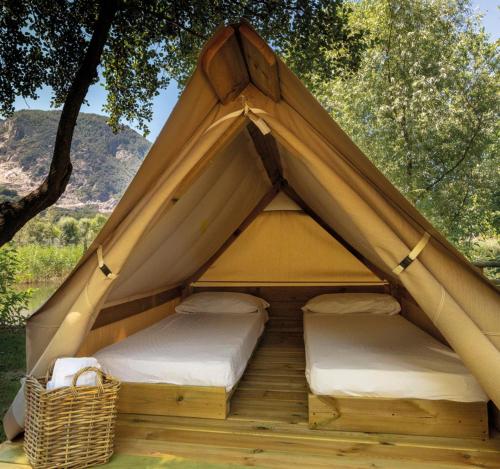 a teepee tent with two beds in it at Camping Daino in Pietramurata