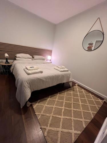 a bedroom with a bed and a mirror on the wall at Pousio- Rural Appartments in Vagos