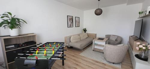 a living room with a table with a game at Útulný byt v centru města in Rychnov nad Kněžnou