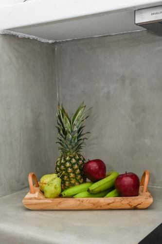 a wooden tray with fruits and vegetables on a counter at Navis apartment in Triovasálos