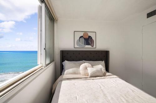 a bedroom with a bed and a large window at Oceanfront Paradise - Spacious and Family Friendly in San Juan