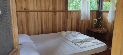 a bedroom with a bed in a wooden room at PLAYA MARIA in Palomino
