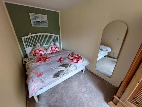 a bedroom with a bed and a mirror at Fewo Frieda in Seehausen