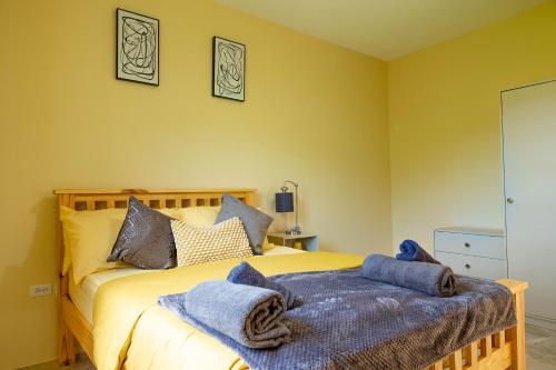 a bedroom with a bed with blue towels on it at Pierocks Highgate Entire house Free Parking and WI-FI in Arnos Vale