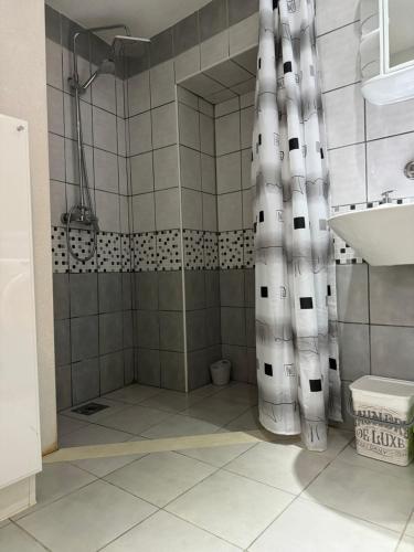 a shower with a shower curtain in a bathroom at Apartment Tena in Senj