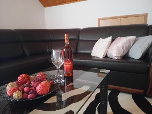a bottle of wine and a glass on a table at Šumska Vila in Bajina Bašta