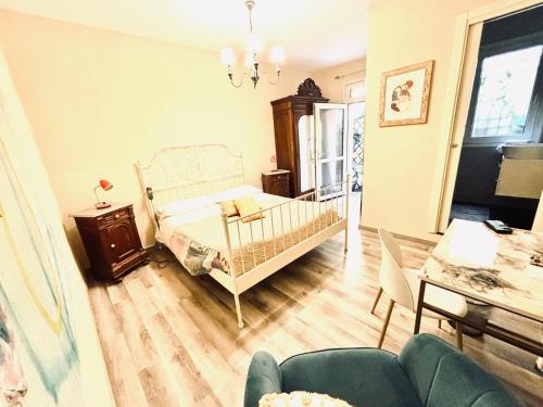a bedroom with a bed and a table and chairs at Dorsoduro House in Venice