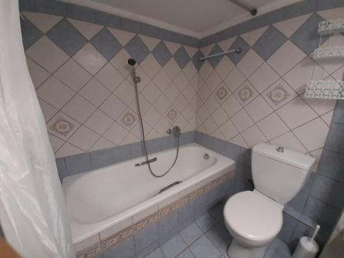 a bathroom with a tub and a toilet and a shower at Spacious and comfy apartment in Nea Moudania