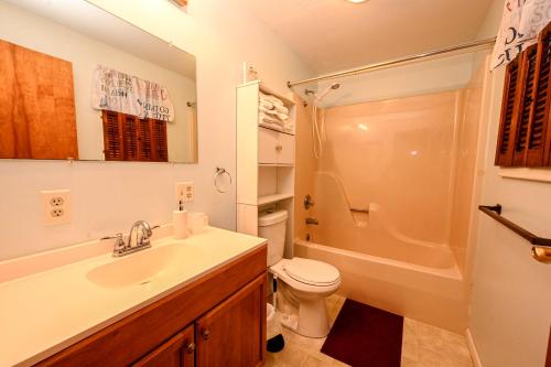 a bathroom with a sink and a toilet and a shower at The Blue Lagoon(1 king,1 queen bed,1 bath , near Niagara Falls & Olcott) in Lyndonville