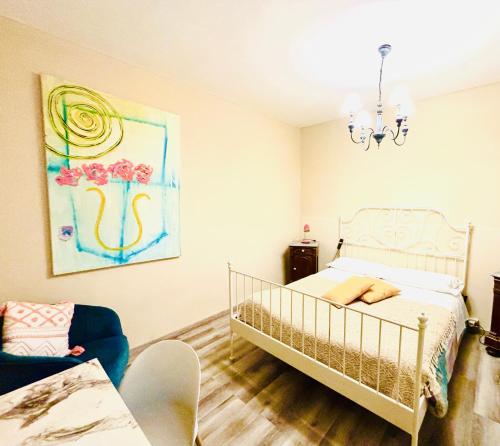 a bedroom with a bed and a chandelier at Dorsoduro House in Venice