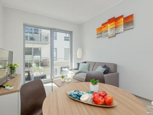 a plate of fruit on a table in a living room at Apartment in Pobierowo near Baltic Beach in Pobierowo