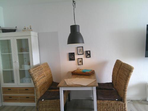 a dining room with a table and two chairs at Fürstenhof Apartment 325 in Grömitz