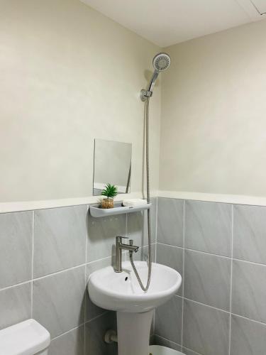 a bathroom with a sink and a mirror at Condo near Airport in Lapu Lapu City