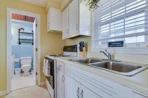 a kitchen with a sink and a toilet at Steps to Ocean North Myrtle Beach Condo with Porch! in Myrtle Beach