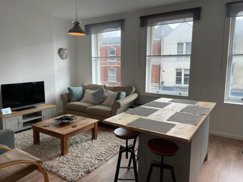 a living room with a couch and a table in it at Wonderful 3 Bed in Old Market in Bristol