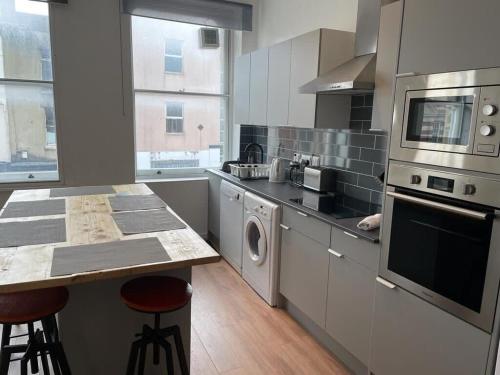 a kitchen with stainless steel appliances and a counter at Wonderful 3 Bed in Old Market in Bristol