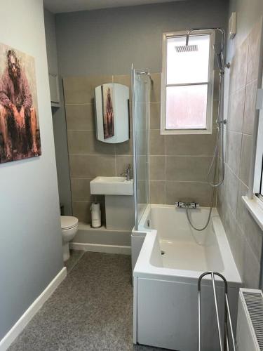 a bathroom with a tub and a toilet and a sink at Wonderful 3 Bed in Old Market in Bristol