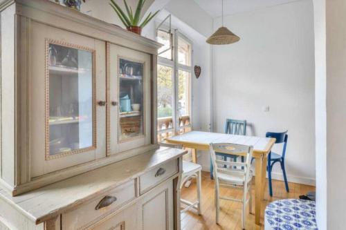 une cuisine avec une armoire en bois et une table dans l'établissement Appartement de charme de 60 m2 entre Montmartre et Batignolles, à Paris