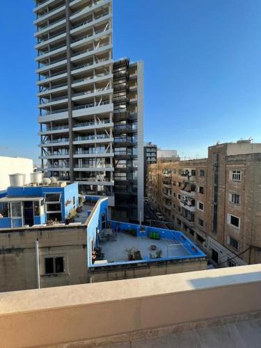 a view of a building from a rooftop with buildings at Sweet 1-bedroom penthouse in the heart of it all in Il-Gżira