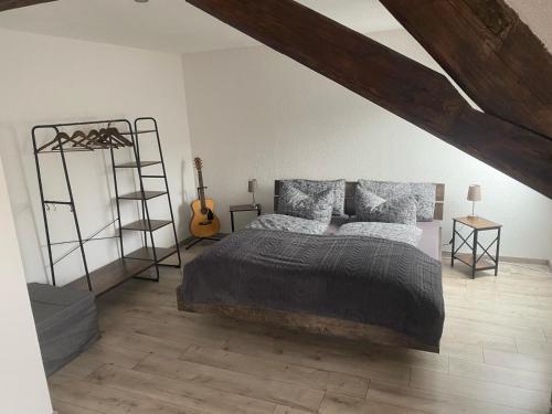 a bedroom with a bed and a wooden floor at Perfekte Auszeit im Erzgebirge in Sayda