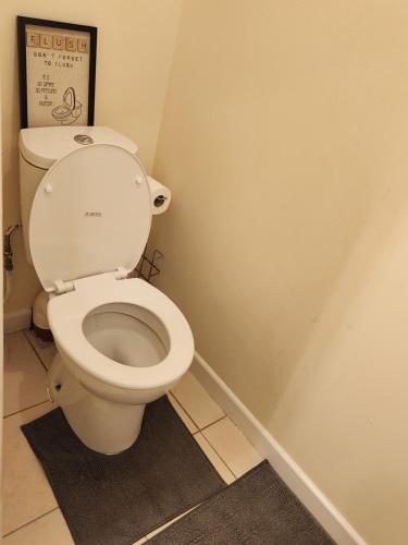 a bathroom with a white toilet in a room at Captivating 3-Bed House in Kent in Kent