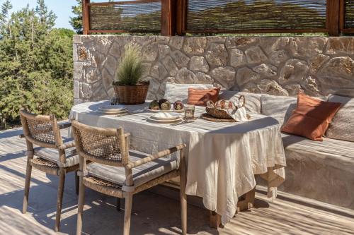 a table and chairs on a patio at Montesea - Luxury Nature Villas in Vasilikos
