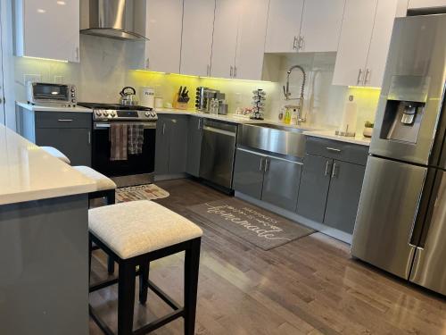 a large kitchen with stainless steel appliances and wooden floors at Hot Tub Four Seasons in Philadelphia