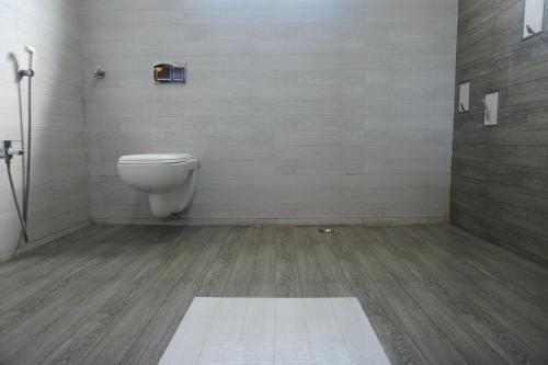 a bathroom with a toilet in a room at Shree Mantra Residency and Homestay in Yercaud