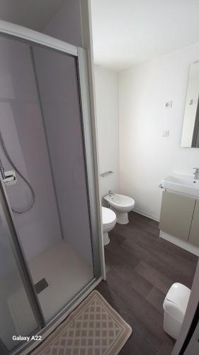 a bathroom with a shower and a toilet and a sink at Parco Vacanze Italia in Albenga