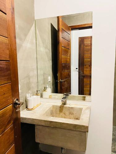 a bathroom with a sink and a mirror at Chhouy Vathna Angkor Boutique in Siem Reap