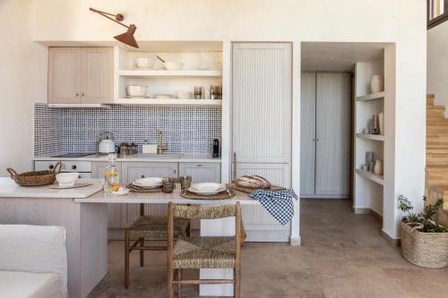 a kitchen with a table with plates on it at Montesea - Luxury Nature Villas in Vasilikos