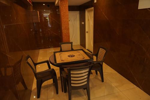 a table and chairs with a box on top of it at Shree Mantra Residency and Homestay in Yercaud