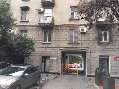 a building with a car parked in front of it at Feel at home chugureti in Tbilisi City