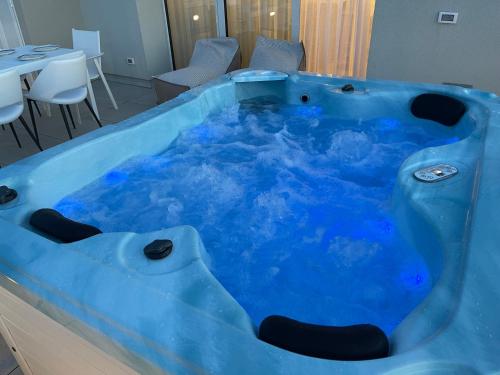 a large blue bath tub in a room at Haus Margarete - Attico Infinity Vista Mare con Jacuzzi - Agenzia Cocal in Caorle