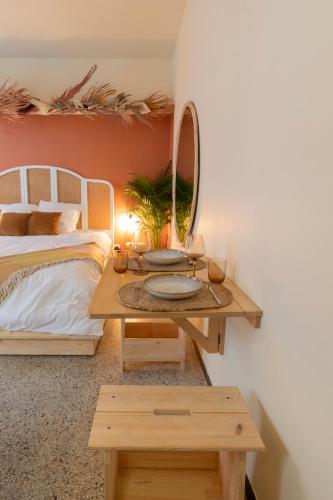- une chambre avec un lit et une table avec un miroir dans l'établissement Un petit nid douillet, à Montpellier
