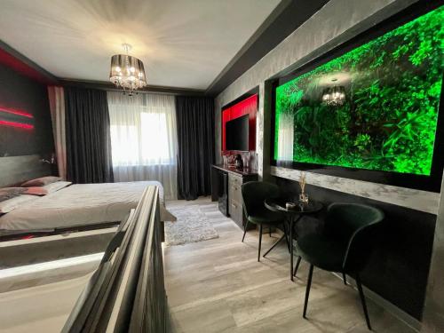 a bedroom with a large monitor on the wall at Nubia studios & spa in Bucharest