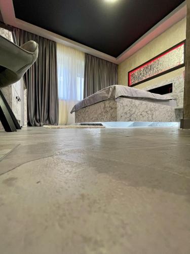 a room with a concrete floor and a bed at Nubia studios & spa in Bucharest